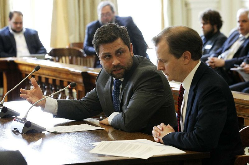 Sen. Jonathan Dismang (left) confers Wednesday with Paul Gehring, assistant commissioner of the Department of Finance and Administration, during a committee hearing on House Bill 1565. More photos at arkansasonline.com/314genassembly/  