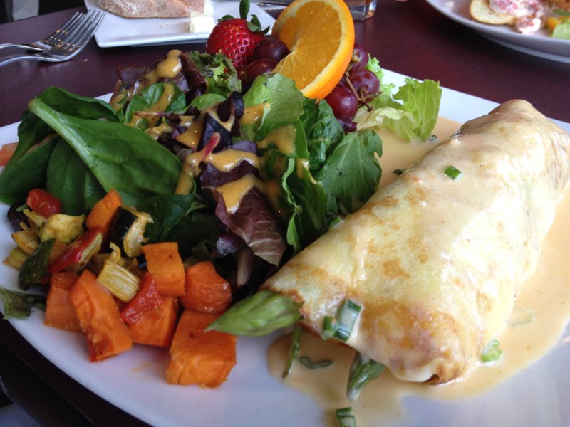 The crepe of the day, covered in lobster sauce and stuffed with crab meat, shrimp, salmon, asparagus and cheese, comes with fruit and a side salad or soup at Brave New Restaurant. (Arkansas Democrat-Gazette/JENNIFER NIXON)