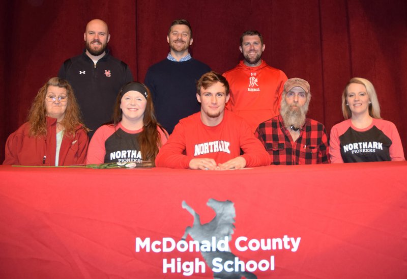 RICK PECK/SPECIAL TO MCDONALD COUNTY PRESS Joseph Brown III (front, center) recently signed a letter of intent to play baseball at North Arkansas College in Harrison, Ark. Front row, left to right: Sue (mom), Kendra (sister), Joseph Brown III, Joe (dad) and Kristy (sister). Back row: MCHS coaches: Bo Bergen, Kevin Burgi and Kellen Hoover.