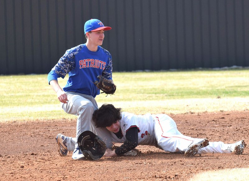 RICK PECK/SPECIAL TO MCDONALD COUNTY PRESS McDonald County Josh Parsons is tagged out while attempting to steal second base in the Mustangs' 3-2 win in a scrimmage held Monday at MCHS.