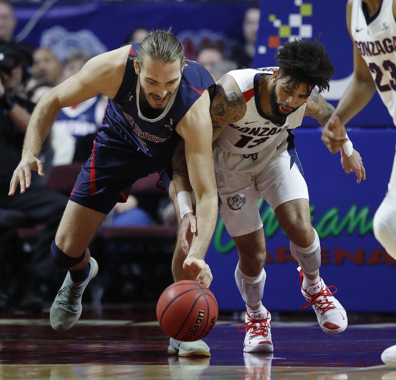 The Associated Press LOOSE BALL: St. Mary's Jock Perry, left, and Gonzaga's Josh Perkins scramble for the ball during the first half Tuesday's game for the West Coast Conference men's tournament title in Las Vegas. story.lead_photo.caption