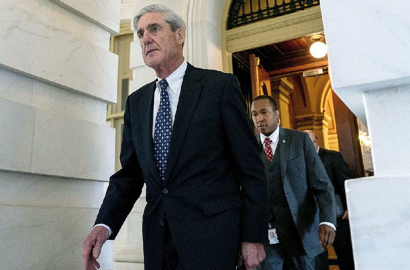 Special counsel Robert Mueller (left) leaves Capitol Hill in June 2017 after a closed meeting with lawmakers. As Mueller appears to be nearing the end of his Russia investigation, the House is calling for any final report from his team to be made public. 