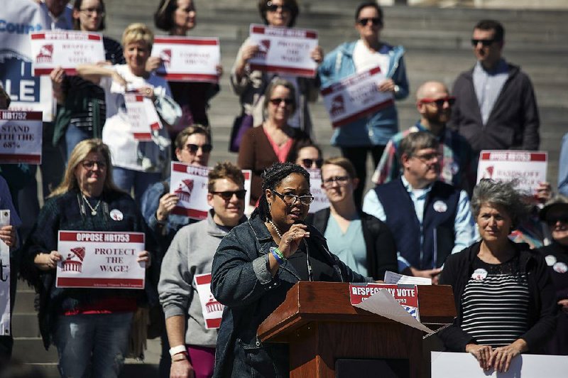 Kmara Seals, policy director for Arkansas Citizens First Congress, speaks at a rally Thursday on the state Capitol steps protesting bills that would add exceptions to the $11 minimum wage bill approved by voters in November.  