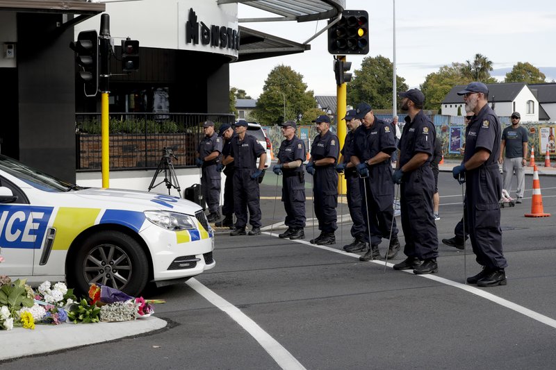 Police officers prepare to search the area near the Masjid Al Noor mosque, site of one of the mass shootings at two mosques in Christchurch, New Zealand, Saturday, March 16, 2019. (AP Photo/Mark Baker)
