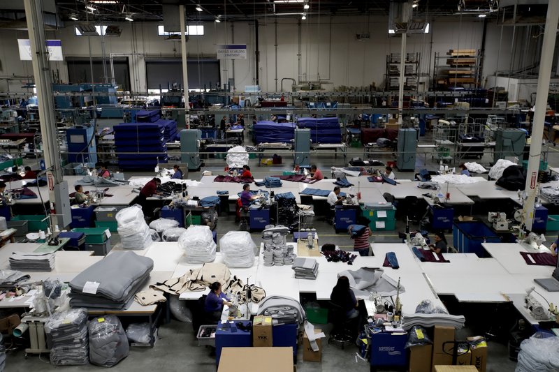 FILE- In this July 5, 2018, file photo workers assemble the Afloat water mattresses at the factory in Corona, Calif. On Friday, March 15, 2019, the Federal Reserve reports on U.S. industrial production for February. (AP Photo/Chris Carlson, File)