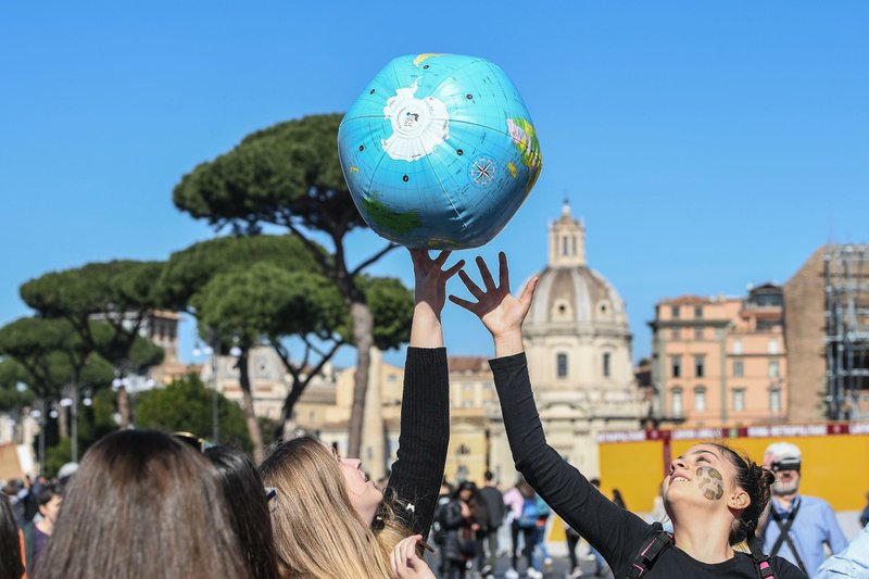 Students play with an inflatable globe as they march to demand action on climate change, in Rome, Friday, March 15, 2019. Students worldwide are skipping class Friday to take to the streets to protest their governments' failure to take sufficient action against global warming. (Alessandro Di Meo/ANSA via AP)
