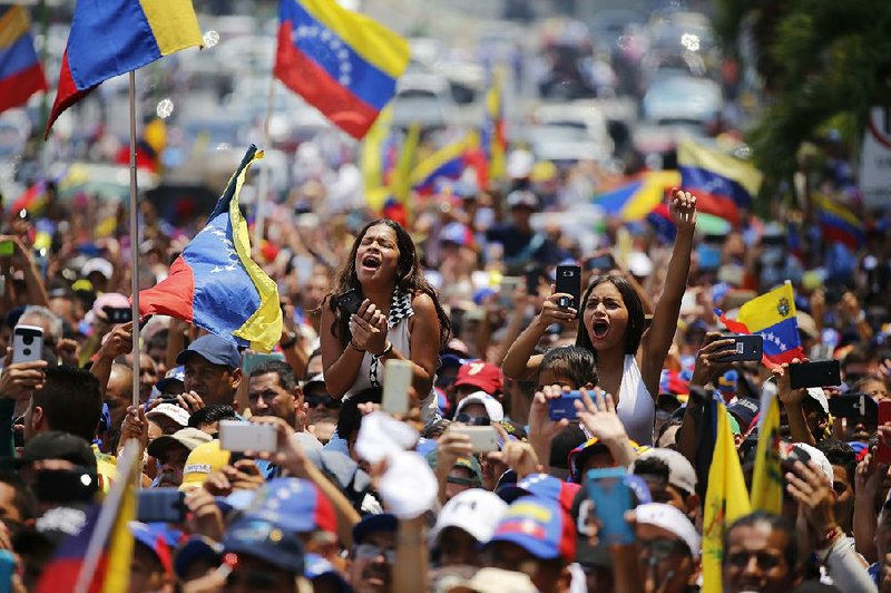 Supporters of Venezuelan National Assembly leader Juan Guaido cheer Saturday during a rally in Valencia. 