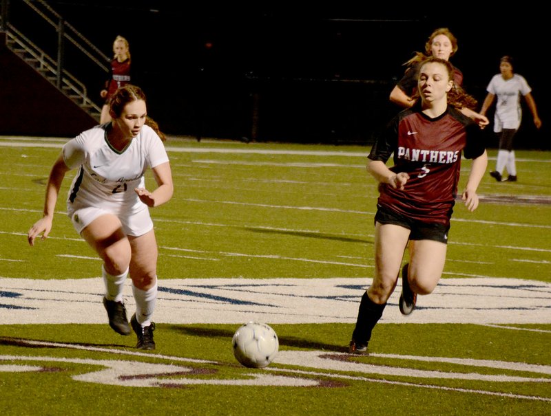 Graham Thomas/Siloam Sunday Alma's Ashlyn Chronister, left, and Siloam Springs junior Brooklyn Shreve run after a loose ball during the first half Tuesday at Panther Stadium. The Siloam Springs girls defeated the Lady Airedales 6-0.