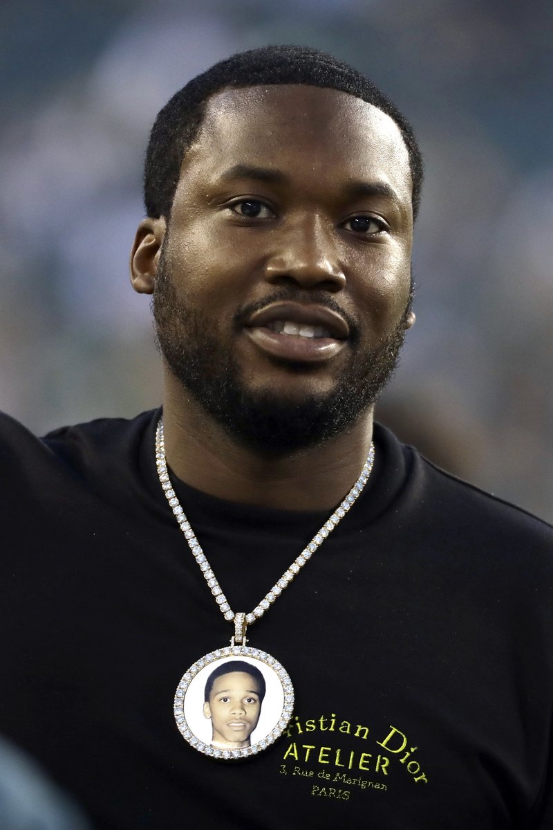 FILE--This file photo from Sept. 6, 2018 shows rapper Meek Mill as he walks the sidelines before an NFL football game between the Philadelphia Eagles and the Atlanta Falcons, in Philadelphia. The Philadelphia City Council announced Thursday, March 14, 2019 that Mill is being honored in his hometown of Philadelphia for his work as a criminal justice reform advocate and as a musician with "Meek Mill Weekend" that will commence Friday. (AP Photo/Michael Perez, File)