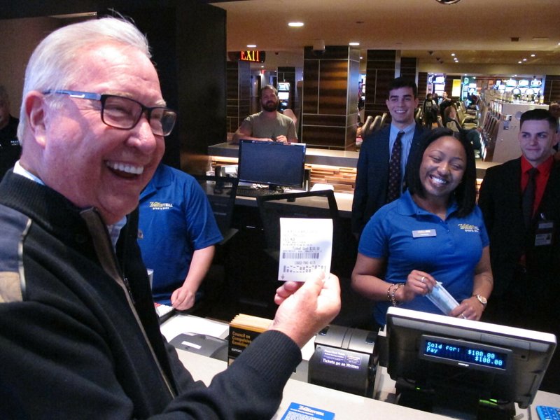 Former Philadelphia Eagles quarterback Ron Jaworski holds a ticket showing his $100 bet on the Philadelphia Phillies to win the 2019 World Series at the Tropicana casino in Atlantic City N.J. on March 8, 2019. Figures released on March 13, 2019 show New Jersey gamblers have wagered almost $2 billion on sporting events since it started nine months ago. (AP Photo/Wayne Parry)