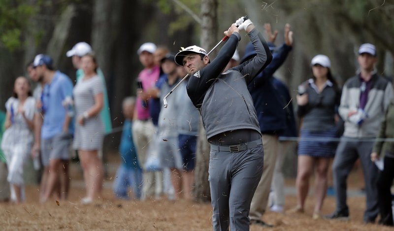 The Associated Press PINESTRAW HIT: Jon Rahm, of Spain, hits from the pinestraw along the 15th hole during the third round of The Players Championship golf tournament Saturday, in Ponte Vedra Beach, Fla.