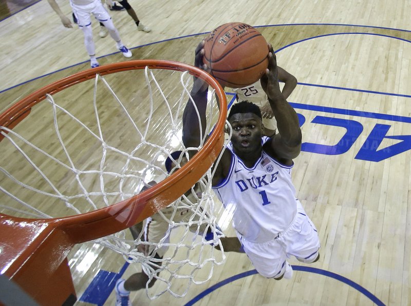 Duke's Zion Williamson (1) goes up to dunk against Florida State during the first half of the NCAA college basketball championship game of the Atlantic Coast Conference tournament in Charlotte, N.C., Saturday, March 16, 2019. (AP Photo/Chuck Burton)