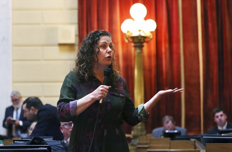 In this March 12, 2019, file photo Rhode Island Rep. Teresa Tanzi addresses legislators during a late afternoon session on gaming at the State House in Providence, R.I. As lawmakers nationwide decide whether to allow sports betting in their state, they're debating whether bets, like almost everything else in our lives, can be managed online or whether wagers should be made only in person. (AP Photo/Charles Krupa, File)