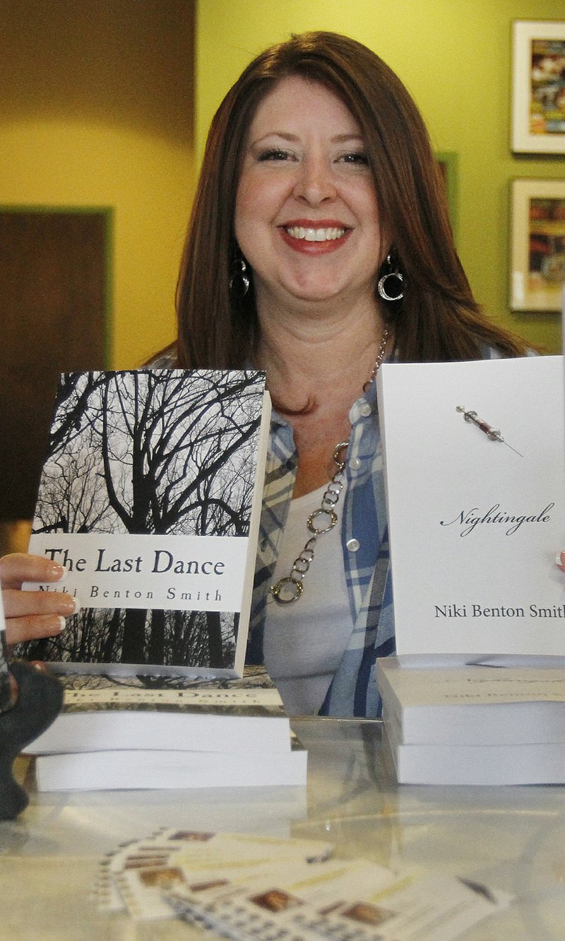Author: El Dorado native and mystery/romance novelist Niki Benton Smith, author of “Nightingale” and “The Last Dance,” holds up two of her novels during a book signing held in 2018 at The Spot. 