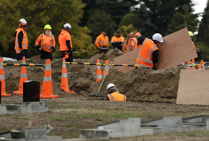 Workers prepare graves today at a Muslim cemetery in Christ-church, New Zealand, as families get ready to bury victims of Friday’s mass shooting. 