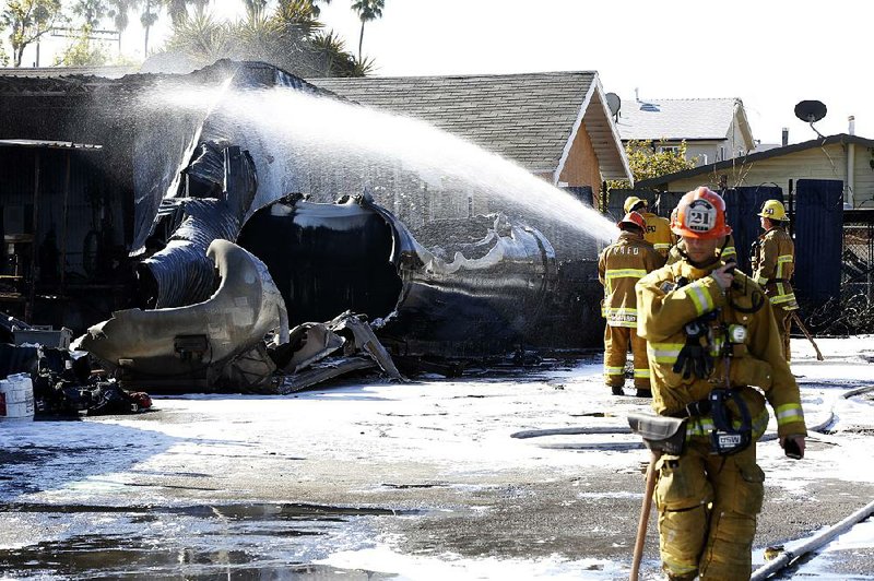 Firefighters douse the tanker truck that exploded Sunday near downtown Los Angeles. 