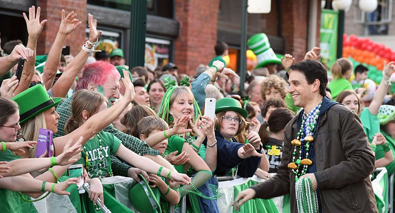 The Sentinel-Record/Grace Brown GRAND MARSHAL: Actor Ralph Macchio greets paradegoers and hands out beaded necklaces on Bridge Street Sunday evening during the First Ever 16th Annual World's Shortest St. Patrick's Day Parade.
