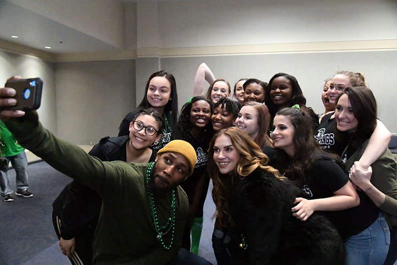 The Sentinel-Record/Grace Brown DREAM REALIZED: The World's Shortest St. Patrick's Day Parade's official starter, Stephen "tWitch" Boss, center, and his wife, Allison, take a selfie with the Hot Springs Dance Troupe Sunday at the Hot Springs Convention Center.