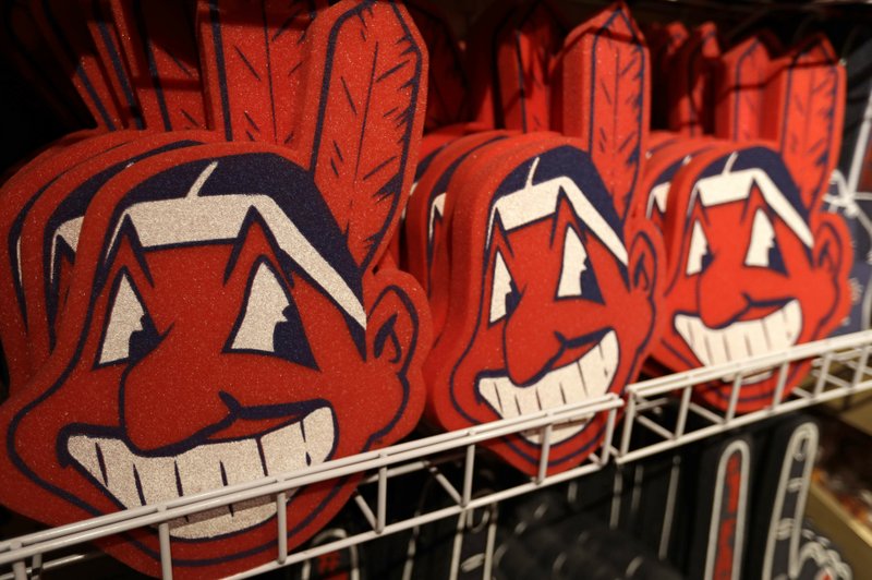 FILE - In this Jan. 29, 2018 file photo, foam images of the MLB baseball Cleveland Indians' mascot Chief Wahoo are displayed for sale at the Indians' team shop in Cleveland. The Chief Wahoo logo is being removed from the Cleveland Indians' uniform in the 2019 season, but the Club will still sell merchandise featuring the mascot in Northeast Ohio. The U.S. has spent most of 2019 coming to grips with blackface and racist imagery, but Native Americans say they don't see significant pressure applied to those who perpetuate Native American stereotypes. (AP Photo/Tony Dejak, File)