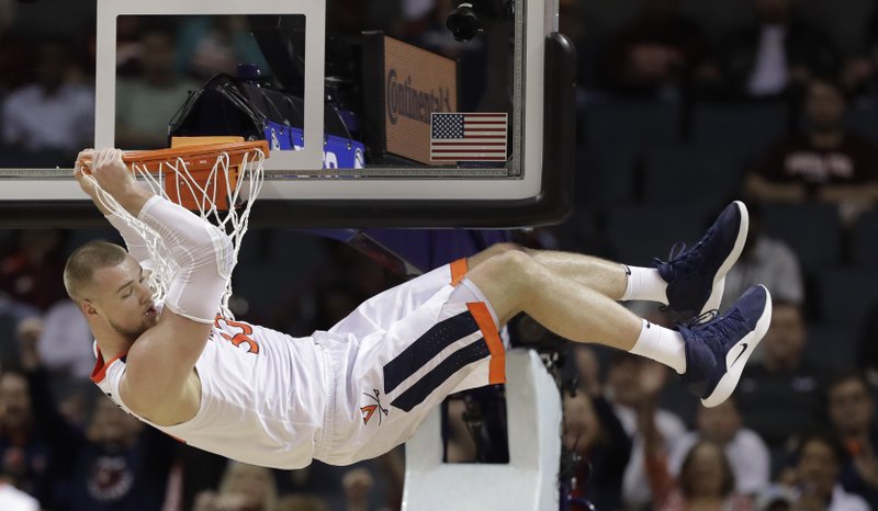 The Associated Press HANGING ON: Virginia's Jack Salt (33) hangs from the rim after a dunk against North Carolina State during the second half of an NCAA college basketball game in the Atlantic Coast Conference tournament in Charlotte, N.C., Thursday. Salt was called for a technical foul on the play.