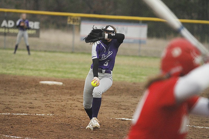 El Dorado pitcher Grace Hargett peers over the top of her glove as she prepares to fire the ball to the plate against Magnolia. The senior has already hurled two no-hitters for the Lady Wildcats, who are 8-0 on the season.