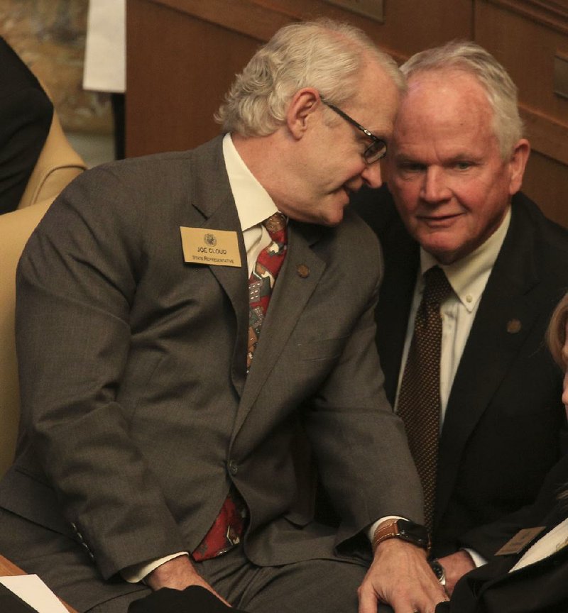Rep. Joe Cloud (left), R-Russellville, talks with Rep. Stephen Magi, D-Conway, on Monday about House Bill 1220 to amend the Tele- medicine Act. The bill failed to pass. More photos are available at arkansasonline.com/319genassembly/.