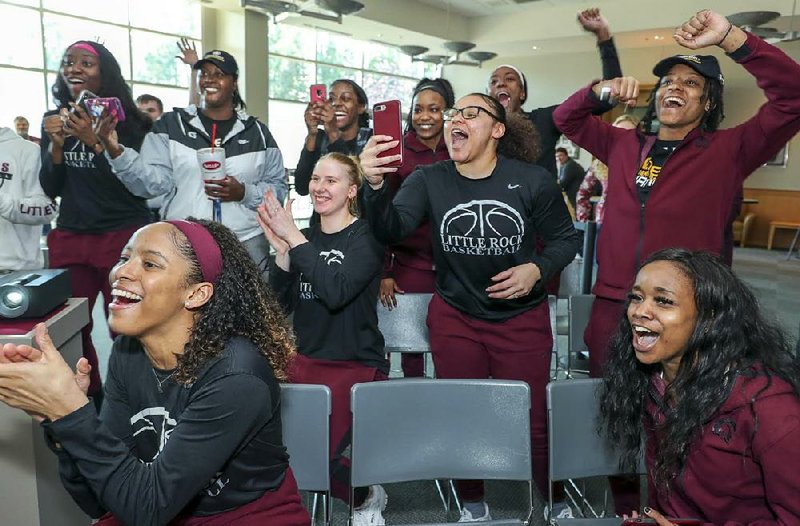 UALR players react during a NCAA Tournament watch party Monday at the Jack Stephens Center in Little Rock. The Trojans will play Gonzaga on Saturday.
