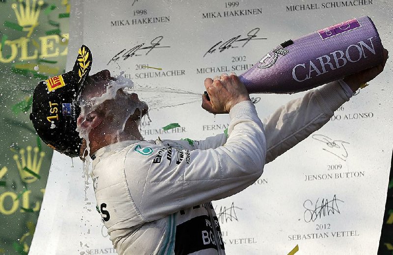 Mercedes driver Valtteri Bottas sprays himself with champagne after winning the Australian Formula 1 Grand Prix on Sunday in Melbourne, Australia.
