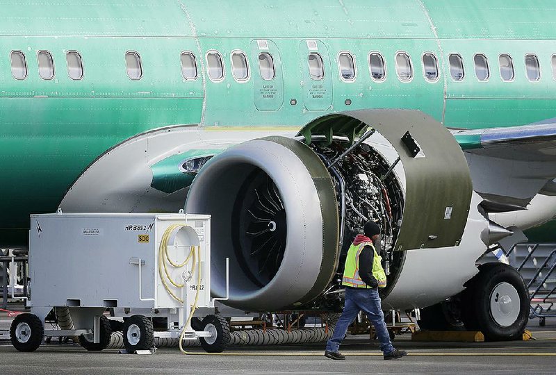 A worker walks past an engine of a Boeing 737 Max 8 airplane being built for American Airlines at Boeing Co.’s assembly plant in Renton, Wash., last week.