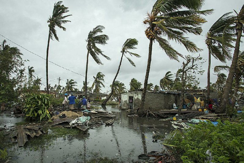 People return to their homes after a cyclone and heavy rain in the coastal city of Beira, Mozambique, on Sunday.