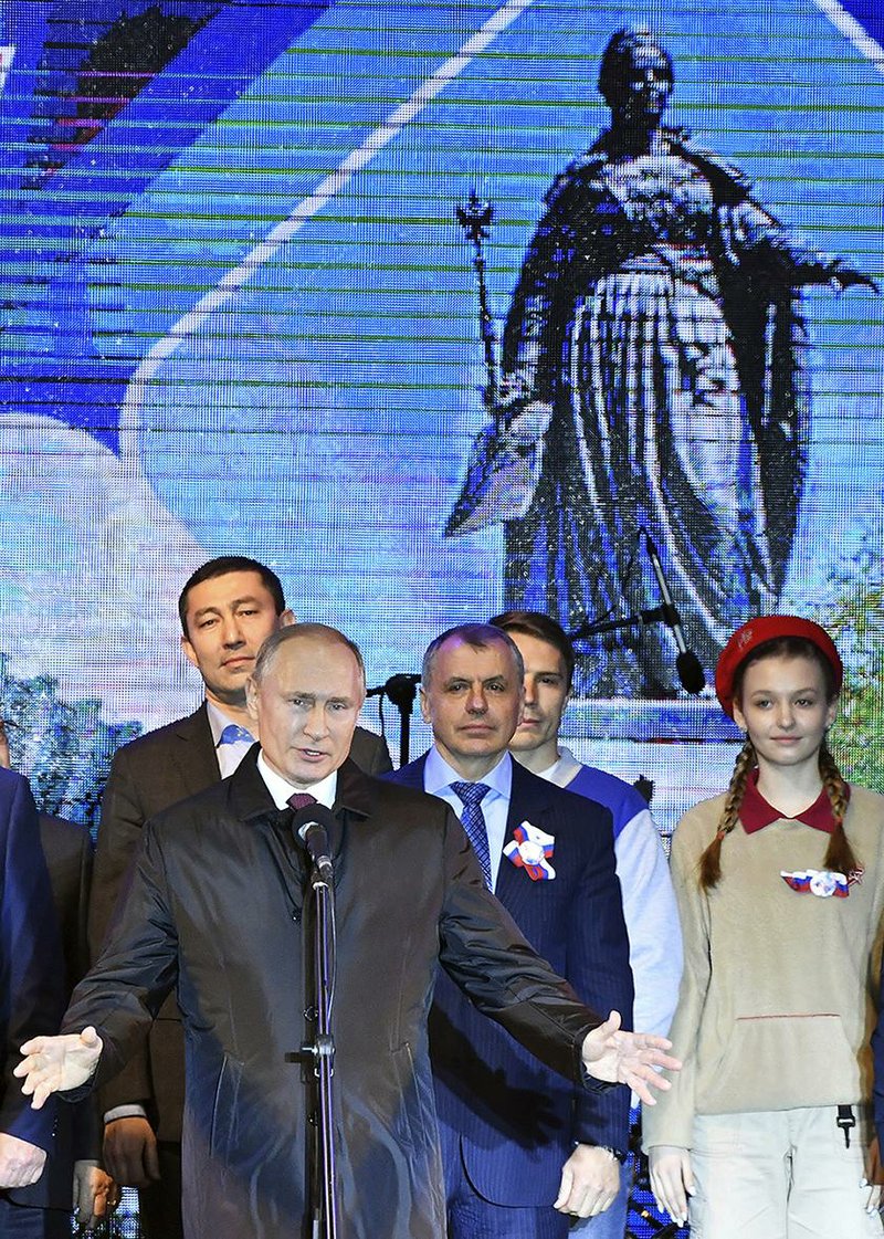 Russian President Vladimir Putin speaks at an outdoor concert in Crimea’s regional capital of Simferopol on Monday.