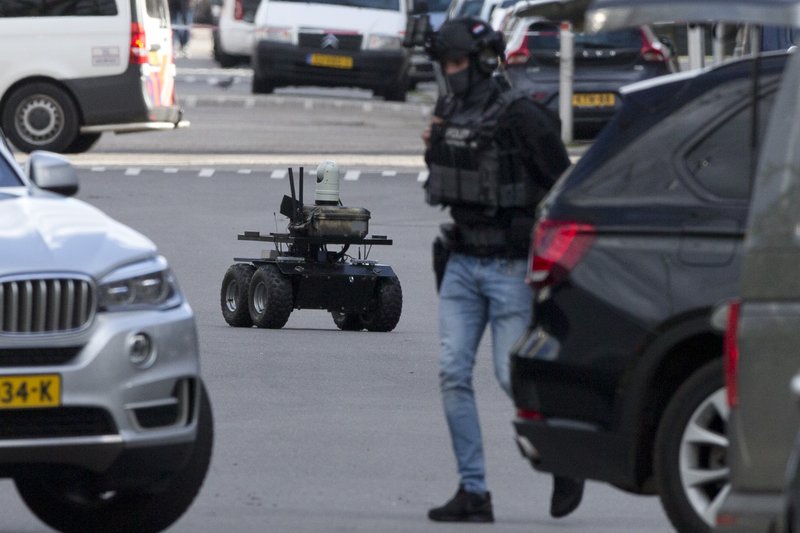 The Associated Press MANHUNT: Dutch counter terrorism police use a robot as they prepare to enter a house after a shooting incident in Utrecht, Netherlands, Monday. A gunman killed three people and wounded nine others on a tram in the central Dutch city of Utrecht, sparking a manhunt that saw heavily armed officers with sniffer dogs zero in on an apartment building close to the shooting.