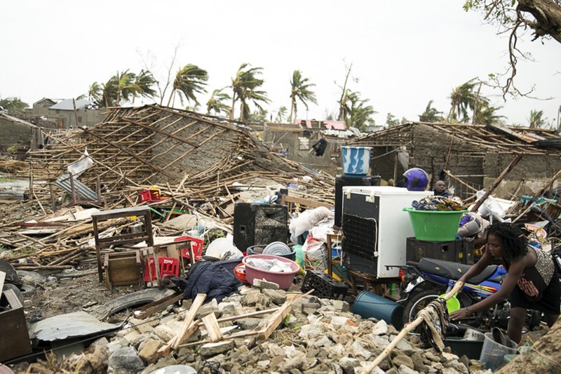 The Associated Press SEA OF RUBBLE: In this photo taken on Friday and provided by the International Red Cross, a woman hangs a cloth to dry in a sea of rubble after Tropical Cyclone Idai, in Beira, Mozambique. Mozambique's President Filipe Nyusi says that more than 1,000 may have by killed by Cyclone Idai, which many say is the worst in more than 20 years. Speaking to state Radio Mozambique, Nyusi said Monday, March 18 that although the official death count is currently 84, he believes the toll will be more than 1,000.