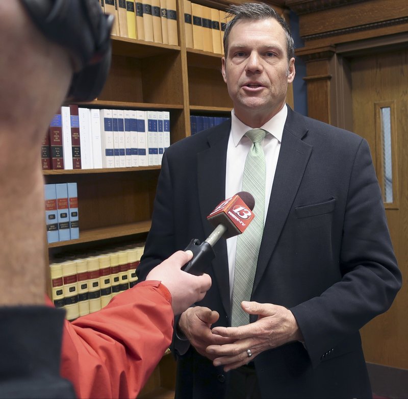 FILE - In this Nov. 30, 2018 file photo, then Kansas Secretary of State Kris Kobach responds to questions from reporters in Topeka, Kan. An appeals court in Salt Lake City, will consider Monday, March 18, 2019, the constitutionality of a struck down Kansas statute that had required people to provide documents proving U.S. citizenship before they could register to vote. (AP Photo/John Hanna, File)