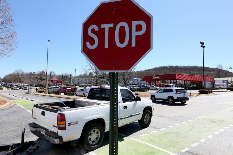 NWA Democrat-Gazette/DAVID GOTTSCHALK Traffic passes through stop signs Friday, March 15, 2019, within the Fiesta Square parking lot in Fayetteville. The first concept maps for Fayetteville&#x221a;&#xa2;&#x201a;&#xc7;&#xa8;&#x201a;&#xd1;&#xa2;s 71B corridor project were released Thursday. A roundabout is suggested at Fiesta Square, which would connect extensions of Appleby Road and Plainview Avenue.