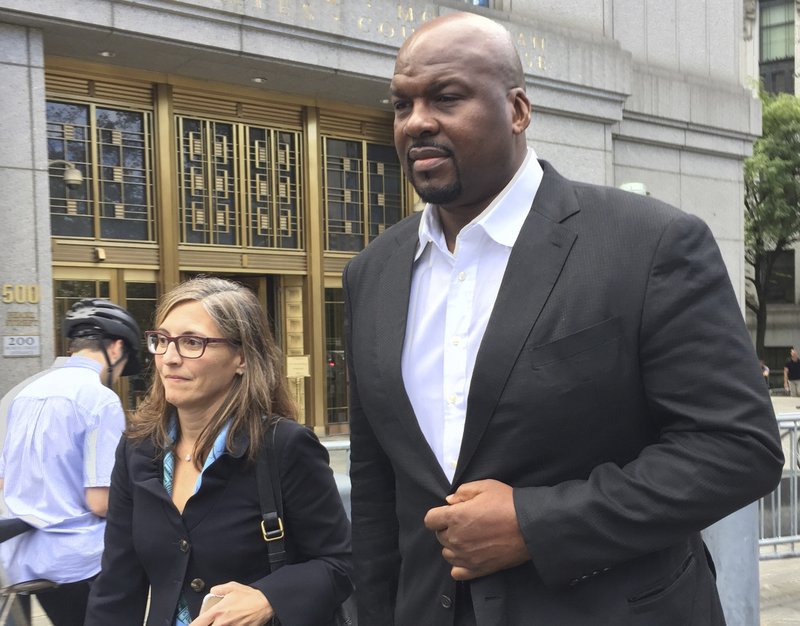 In this Oct. 10, 2017 file photo, former Auburn University assistant men's basketball coach, Chuck Person (right), leaves Manhattan federal court in New York, after an initial appearance before a magistrate judge. 