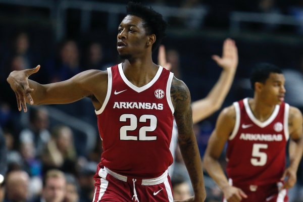 Arkansas' Gabe Osabuohien (22) reacts after making a three-pointer during the first half of a first round NCAA National Invitation Tournament college basketball game against Providence in Providence, R.I., Tuesday, March 19, 2019. (AP Photo/Michael Dwyer)