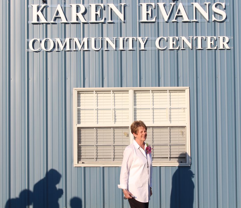 Honor: Former Calion Mayor Karen Evans stands in front of the now renamed Karen Evans Community Center in Calion after the formal unveiling during a reception Tuesday honoring Evans' service to the community. Madeleine Leroux/News-Times