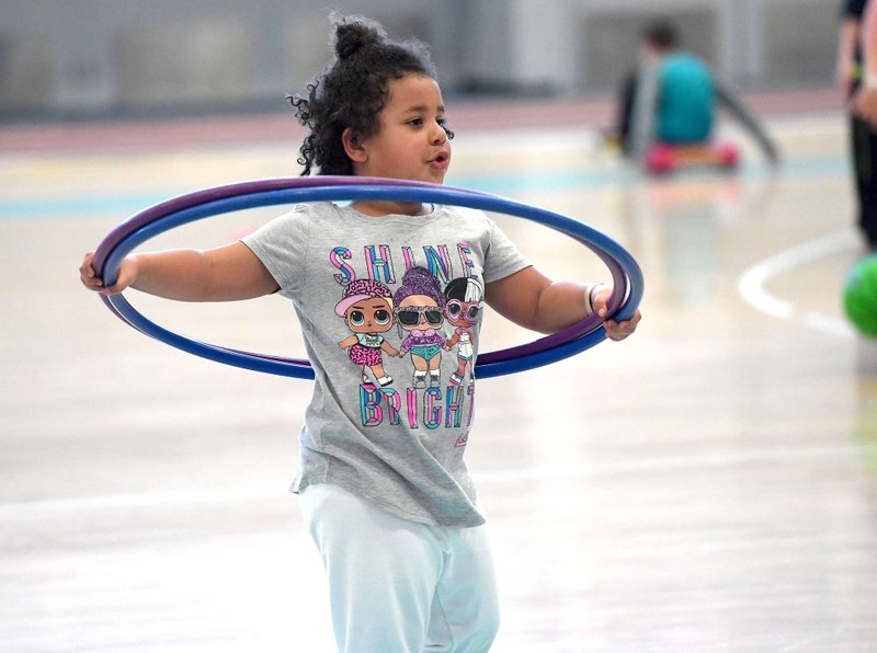 NWA Democrat-Gazette/J.T. WAMPLER Izzy Ochieng, 5, of Fayetteville plays with a hula-hoop Monday March 18, 2019 at the Jones Center in Springdale. The center is open all week for spring break with extended hours. The pool, gym and rink will be open all week with a special activity scheduled for each day through week. For information on activities at the Jones Center visit www.thejonescenter.net