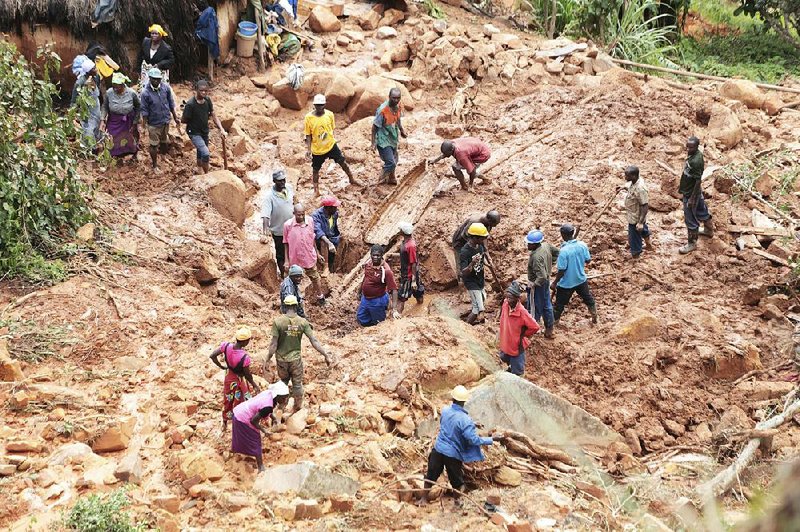 A family digs Tuesday for a relative who was buried in a mudslide after Cyclone Idai struck Thursday in Chimanimani, Zimbabwe. 