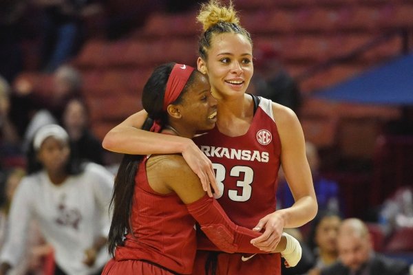 Arkansas' Cheksea Dungee, right, and Malica Monk celebrate after an NCAA college basketball game against Texas A&M in the Southeastern Conference women's tournament Saturday, March 9, 2019, in Greenville, S.C. (AP Photo/Richard Shiro)