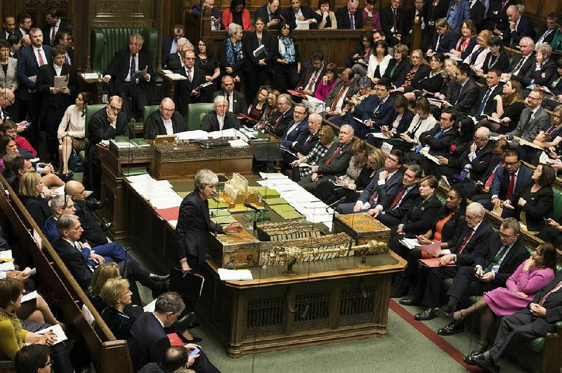 British Prime Minister Theresa May (lower left) speaks during question time Wednesday in the House of Commons as she again seeks Parliament approval for her twice-rejected European Union exit plan.