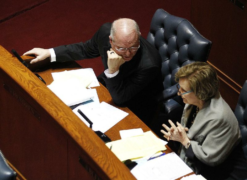 Senate President Pro Tempore Jim Hendren talks with Sen. Cecile Bledsoe on Wednesday after Hendren’s bill to provide $97 million a year in income tax cuts largely for low- and moderate-income Arkansans through a tax increase on tobacco products was narrowly approved. The bill faces a tough hurdle in the House Revenue and Taxation Committee. More photos are available at arkansasonline.com/321genassembly/. 