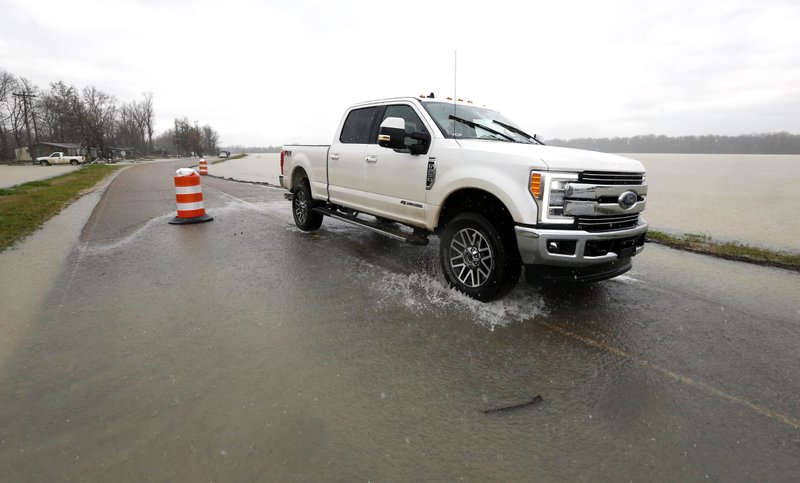 In this Monday, March 11, 2019 photo, backflow waters flood a section of Mississippi 16 near Rolling Fork, Miss. In March 2019, scientists are warning that historic flooding could soon deluge parts of several southern states along the lower Mississippi River, where flood waters could persist for several weeks. (AP Photo/Rogelio V. Solis)

