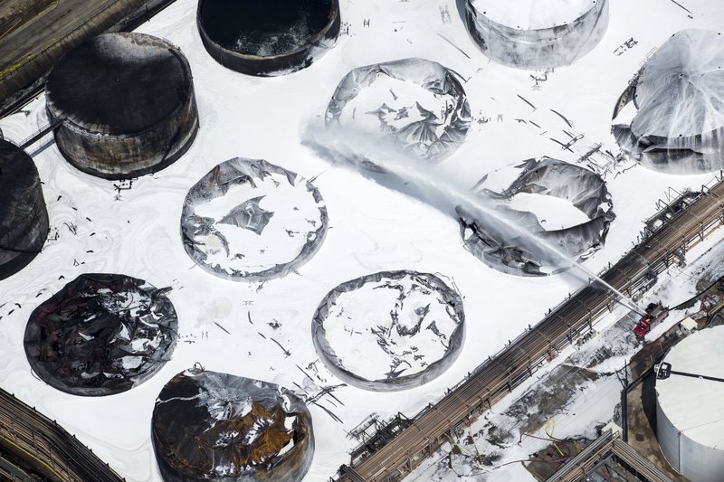 Emergency crews continue to douse what's left of the now-extinguished petrochemical tank fire at Intercontinental Terminals Company on Wednesday, March 20, 2019, in Deer Park. Fire crews extinguished the blaze at ITC about 3 a.m., Wednesday, almost four days after it started, which caused a plume of black smoke to linger over the Houston area. ITC officials said the cause of the fire is still unknown. EPA on-site coordinator Adam Adams said they have been in Deer Park since Sunday, conducting air monitoring at ground level and in the plume. Biggest concerns are "volatile organic chemicals" and particulates, Adams said. He added that no hazardous levels have been detected. (Brett Coomer/Houston Chronicle via AP)

