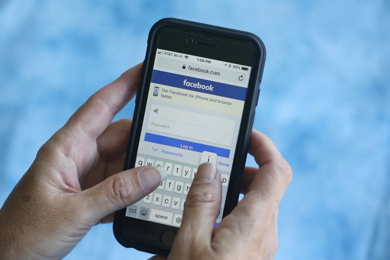 FILE- In this Aug. 21, 2018, file photo a Facebook start page is shown on a smartphone in Surfside, Fla. Facebook said Thursday, March 21, 2019, that it stored millions of its users’ passwords in plain text for years. The acknowledgement from the social media giant came after a security researcher posted about the issue online. (AP Photo/Wilfredo Lee, File)