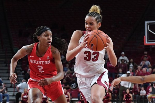 Arkansas' Chelsea Dungee drives to the basket between Houston's Octavia Barnes (LEFT) and Angela Harris Thursday March 21, 2019 at Bud Walton Arena in Fayetteville during the first round of the Women's National Invitational Tournament. Arkansas won 88-80 in overtime. The Razorbacks take on University of Alabama at Birmingham at home on Sunday.
