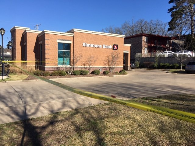 Crime scene tape blocks off the Simmons Bank parking lot after the branch in Little Rock's Hillcrest neighborhood was robbed at gunpoint Thursday morning.