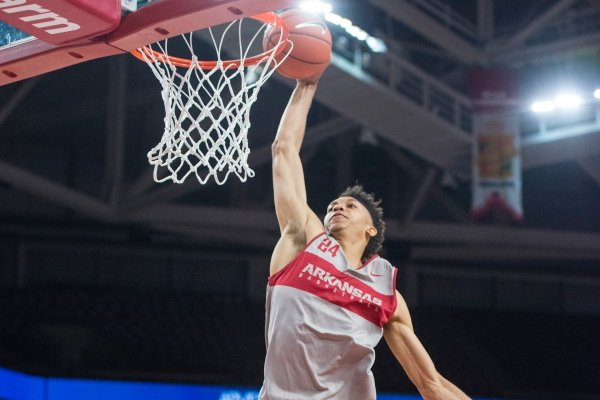 Ethan Henderson takes his turn in a slam dunk contest Friday, Oct. 19, 2018, before the Arkansas Red and White scrimmage at Bud Walton Arena in Fayetteville.