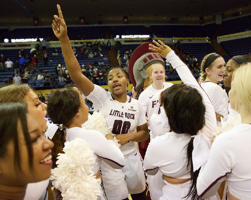 UALR forward Ronjanae DeGray (00) celebrates with teammates and cheerleaders after the Trojans’ victory in the Sun Belt Conference Tournament final March 16. The Trojans take on Gonzaga today in the NCAA Women’s Tournament.